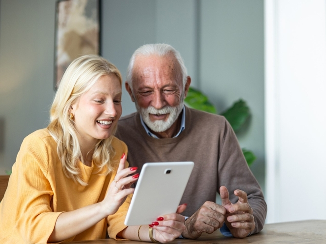daughter and father on ipad