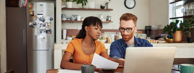 woman and man discussing finances at kitchen table